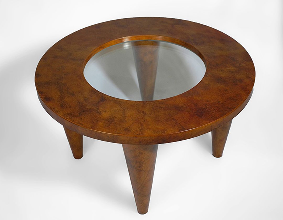 Round coffee table in wood and glass covered with leather and finished with shellac